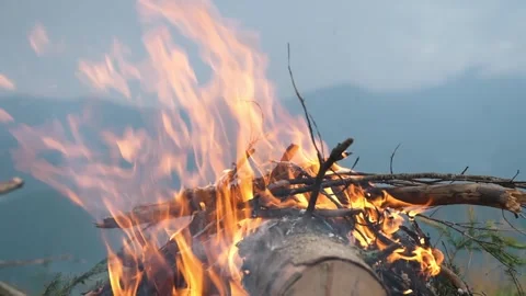 A beautiful fire burns on the background of beautiful mountain nature. Campfire Stock Footage 271599016