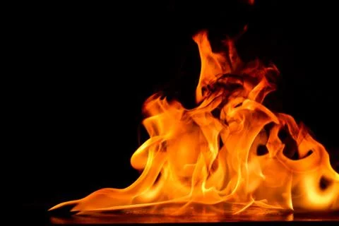 Beautiful fire flames on a black background. Stock Photos