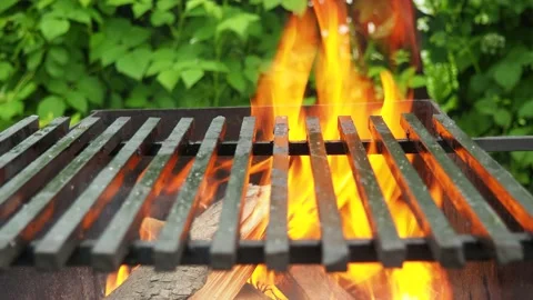 Beautiful fire in the grill. flames pass through the grill 4K Stock Footage 134904610