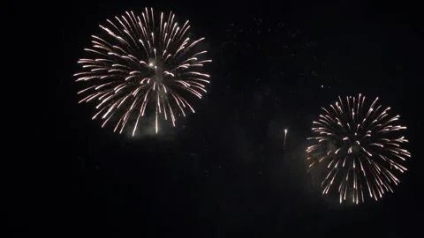 A beautiful firework display lighting up the night sky with bright golden Stock Footage 337463902