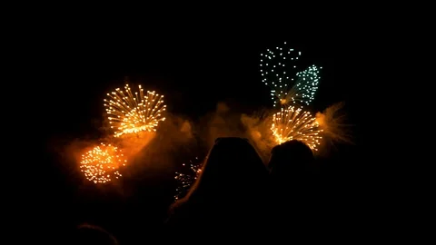 Beautiful fireworks explode against the night sky Stock Footage 107813713