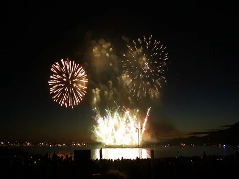 Beautiful fireworks over ocean surface summer night Stock Footage 78209446