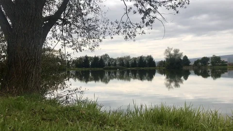 Beautiful fish pond near Badin, Banska Bystrica, Slovakia. Fishing place. Clouds Stock Footage 117911077