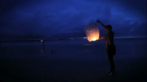 A beautiful flame displaying in the breeze at sunset on the beach Stock Footage 35520342