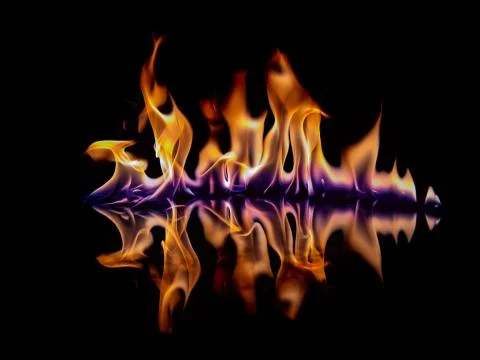 Beautiful flame with reflection on a black background. Stock Photos