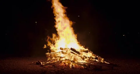 Beautiful flames of bonfire burn in the middle of the night in slowmotion Stock Footage 277352092