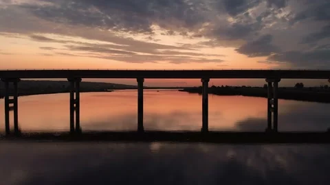 Beautiful flight under the bridge over the river at dawn. Stock Footage 147963956