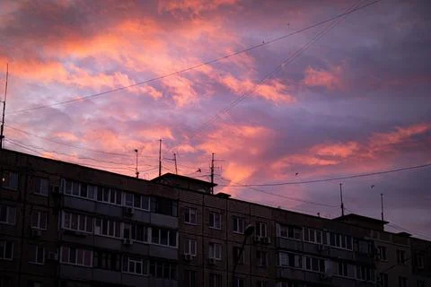 Beautiful floating clouds bright red float over the cityscape Stock Photos