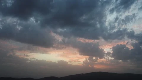 Beautiful floating clouds over the mountains at sunset Stock Footage 149856817