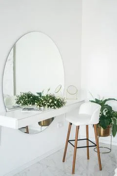 Beautiful flower branches on dressing table in room. Interior design Stock Photos