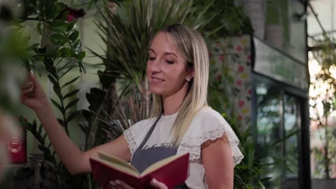 Beautiful Flower Shop Worker Checking Flowers And Holding Clipboard Stock Footage 201866504