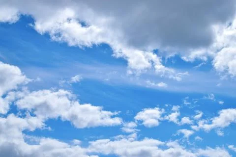 Beautiful fluffy clouds on a blue sky with sunshine Stock Photos