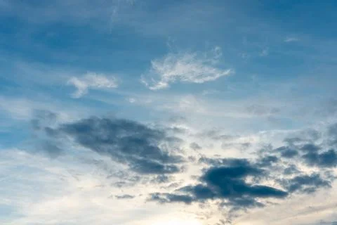 Beautiful fluffy clouds in the evening sky. The sunlight gives a side light o Stock Photos