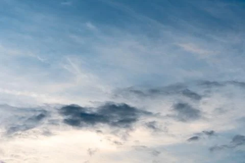 Beautiful fluffy clouds in the evening sky. The sunlight gives a side light o Stock Photos