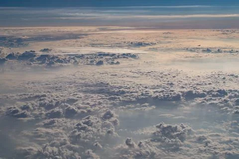 Beautiful fluffy clouds from the window of the plane Stock Photos