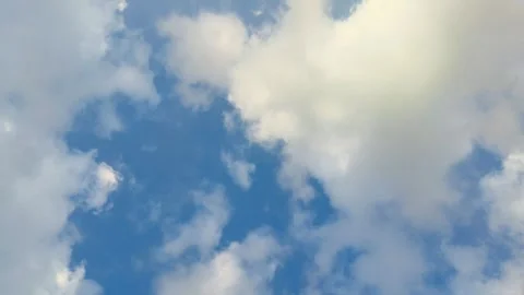 Beautiful fluffy cumulus clouds drifting across vibrant blue sky on sunny d.. Stock Footage 345424484