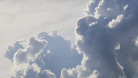 Beautiful fluffy cumulus clouds forming on summer sky Stock Footage 318395155