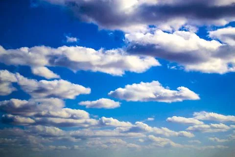 Beautiful fluffy white clouds on a deep blue sky Stock Photos