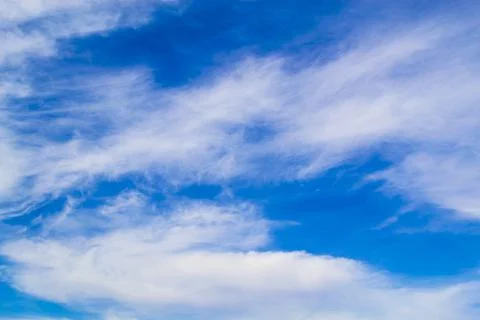 Beautiful fluffy white clouds on a deep blue sky Stock Photos