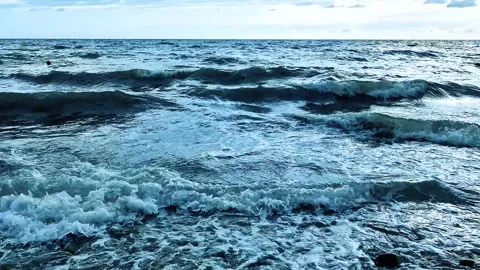 Beautiful Foaming Waves in the Ocean Blue Sky Clouds Beach Close Up Slow Motion. Video stock 286212260