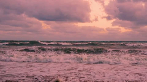 Beautiful Foaming Waves in the Ocean Yellow Orange Sunset Sky Lilac Pink Purple  Stock Footage 286430125