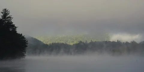 Beautiful fog floating across Lake Santeetlah at dawn Stock Footage 103782953