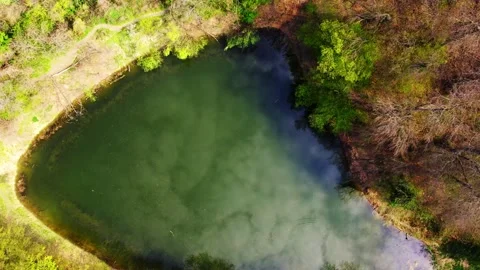 Beautiful footage of a reflection of cloudy sky on a lake's surface Stock Footage 260088673