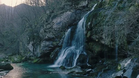 Beautiful forest waterfall in the middle of the Alps in winter Stock Footage 228097589