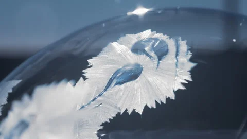 Beautiful freezing pattern forming on a soap bubble in winter Stock Footage 276388965
