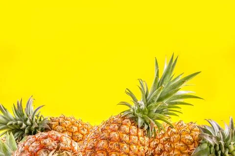 Beautiful fresh pineapple isolated on bright yellow background, summer seas.. Stock Photos