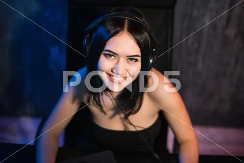 Beautiful Friendly Pro Gamer Girl Does Video Game Gameplay stream, Wearing Stock Photos