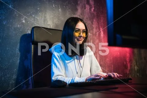 Beautiful Friendly Pro Gamer Girl Does Video Game Gameplay stream, Wearing Stock Photos