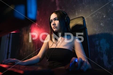 Beautiful Friendly Pro Gamer Girl Does Video Game Gameplay stream, Wearing Stock Photos