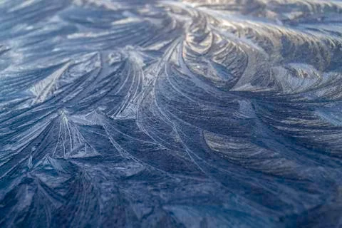 Beautiful frosty pattern an equal surface in winter morning. Stock Photos