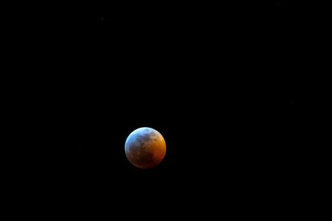 Beautiful full lunar eclipse against a black background at night Stock Photos