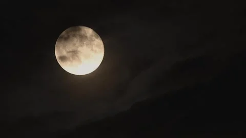 Beautiful full moon rise through drifting dark clouds captured in cinematic time Stock Footage 305428947