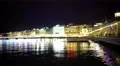 Beautiful Geneva lake at night, reflections in water, people walk on embalmment 4k or 4k+ Resolution