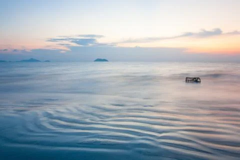 Beautiful gently waves. Ripple marks and traditional Thai fish trap in the oc Stock Photos