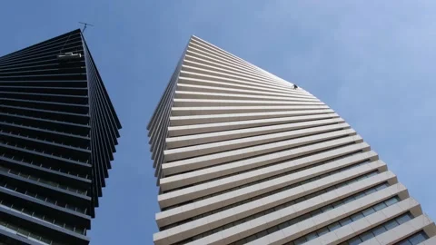A beautiful geometric shape of two high-rise office buildings located side .. Stock Footage 235043778