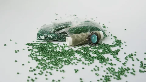 Beautiful Ggreen Beads on a Background of Sewing Accessories. White Background Stock Footage 123073611