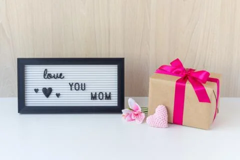 A beautiful gift and a decorative sign with the message: love YOU MOM. Stock Photos