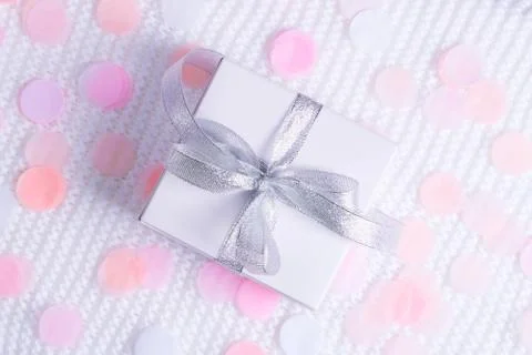 Beautiful gift box on white background with confetti. Stock Photos