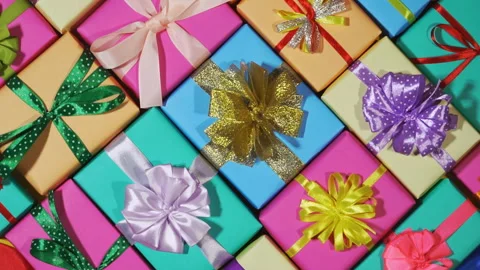 Beautiful gift boxes wrapped in colored wrapping paper with ribbon bows 動画素材 100087979