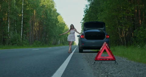 A beautiful girl asks for help while on the road, the car broke down in the Stock Footage 209979019