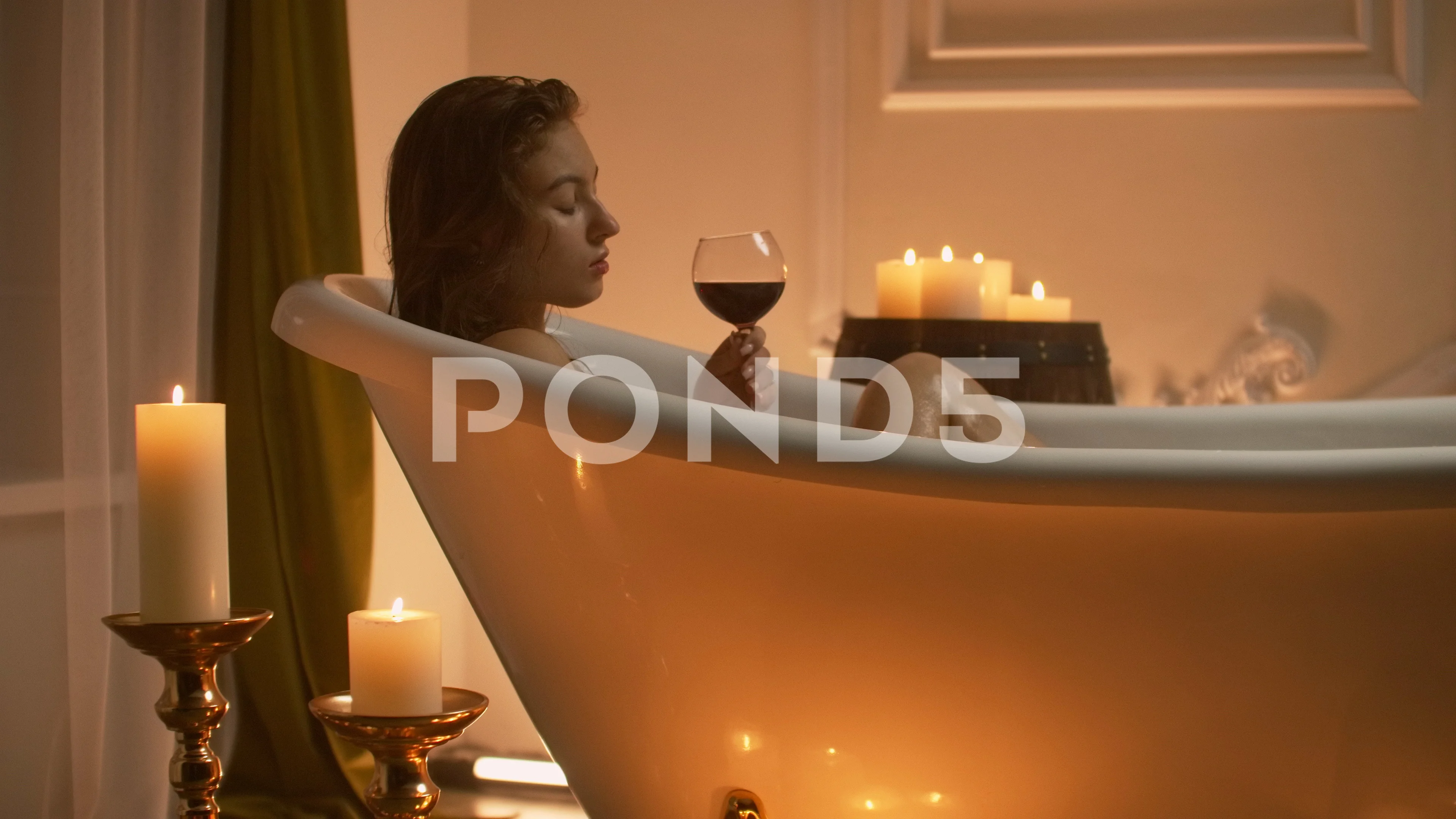 https://images.pond5.com/beautiful-girl-bathtub-candles-glasses-footage-121670495_prevstill.jpeg