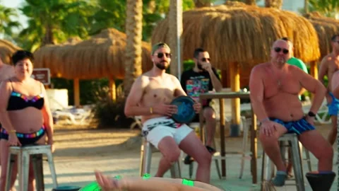 Beautiful girl belly dancing in front of tourists on the beach. Stock Footage 329059631