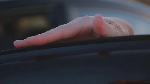 Beautiful girl in black shoes and red dress gets out of the car in the evening Stock Footage