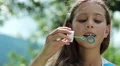 Beautiful girl blowing soap bubbles HD Footage