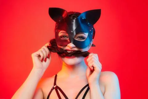 Beautiful girl in a cat mask. playfully posing in front of the camera Stock Photos