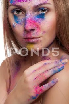 Beautiful girl with colour powder on face Stock Photos